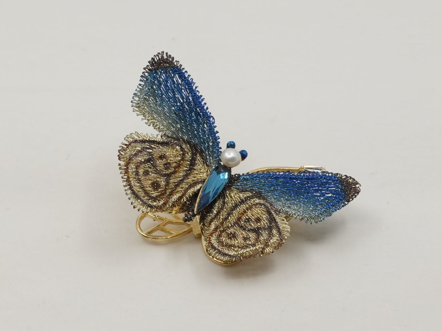 Butterfly-shaped object on a light gray background