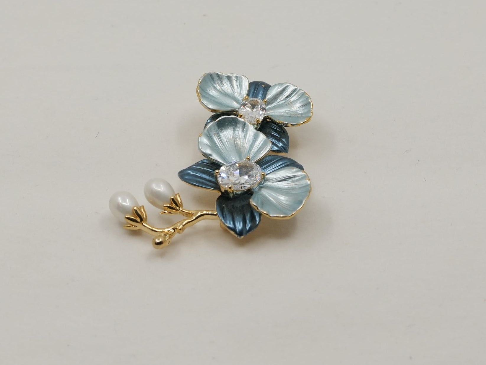 Floral earring with blue stones on a beige background