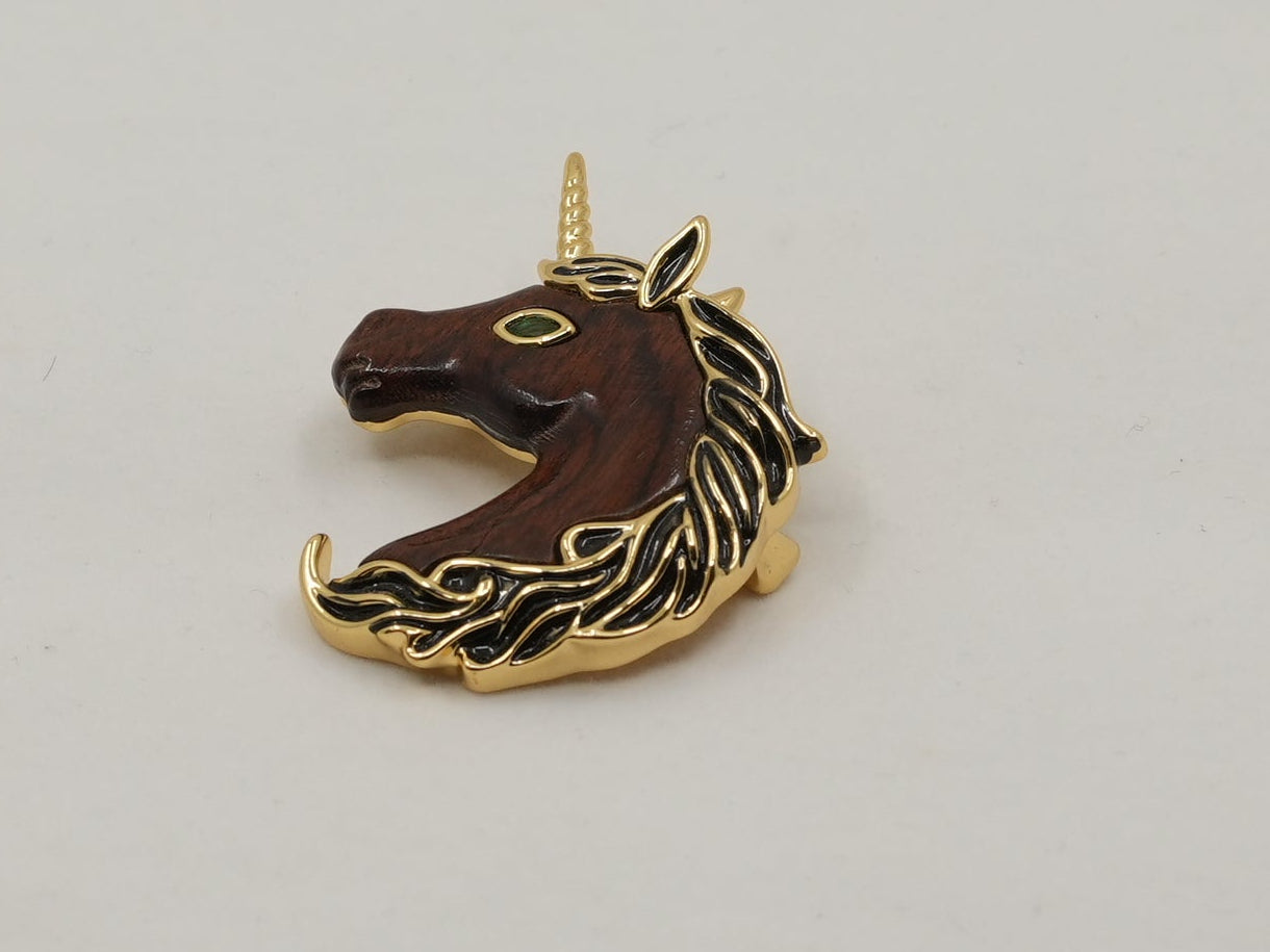 Unicorn-shaped pendant on a light gray background