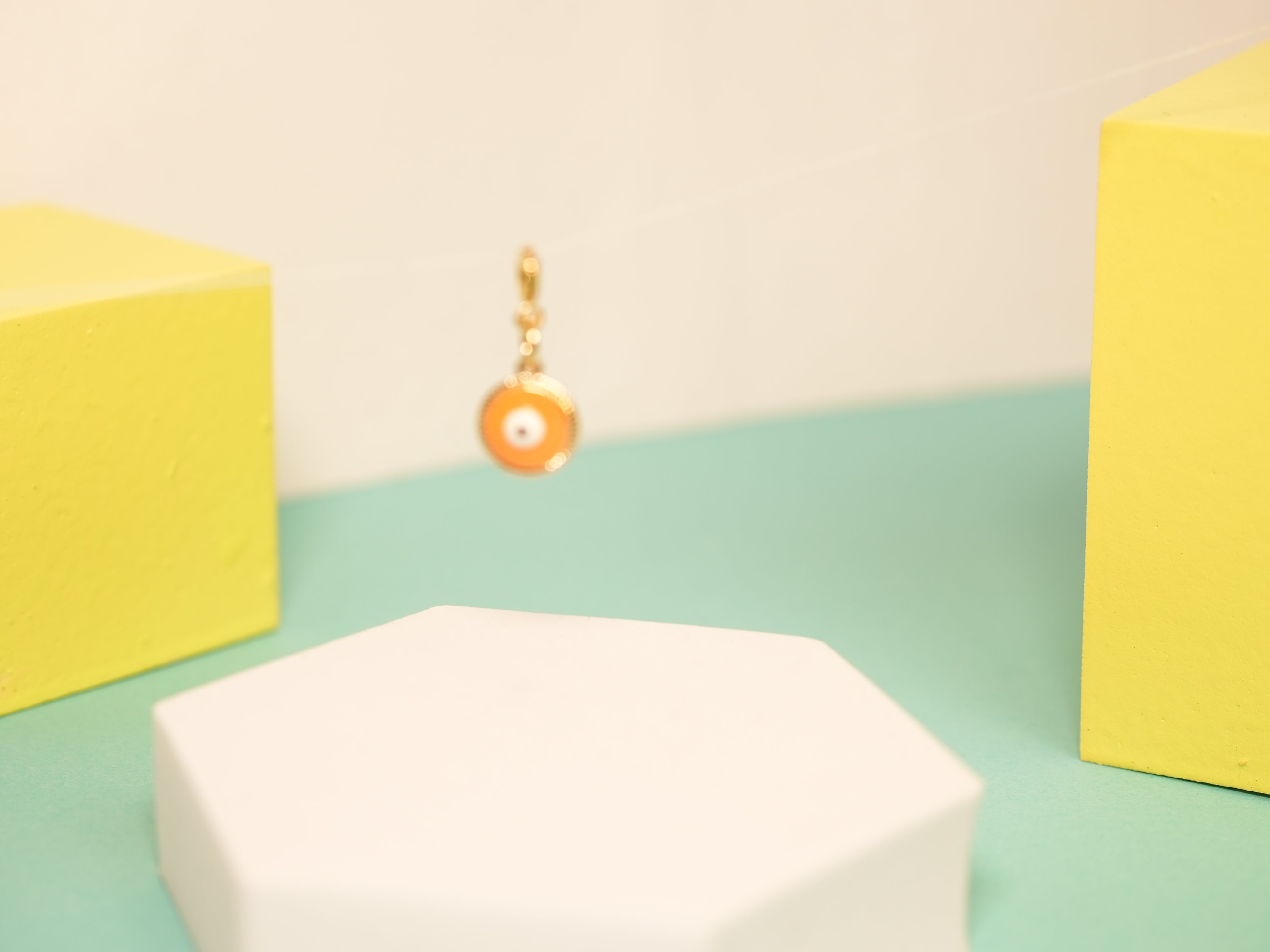 Orange pop evil eye charm