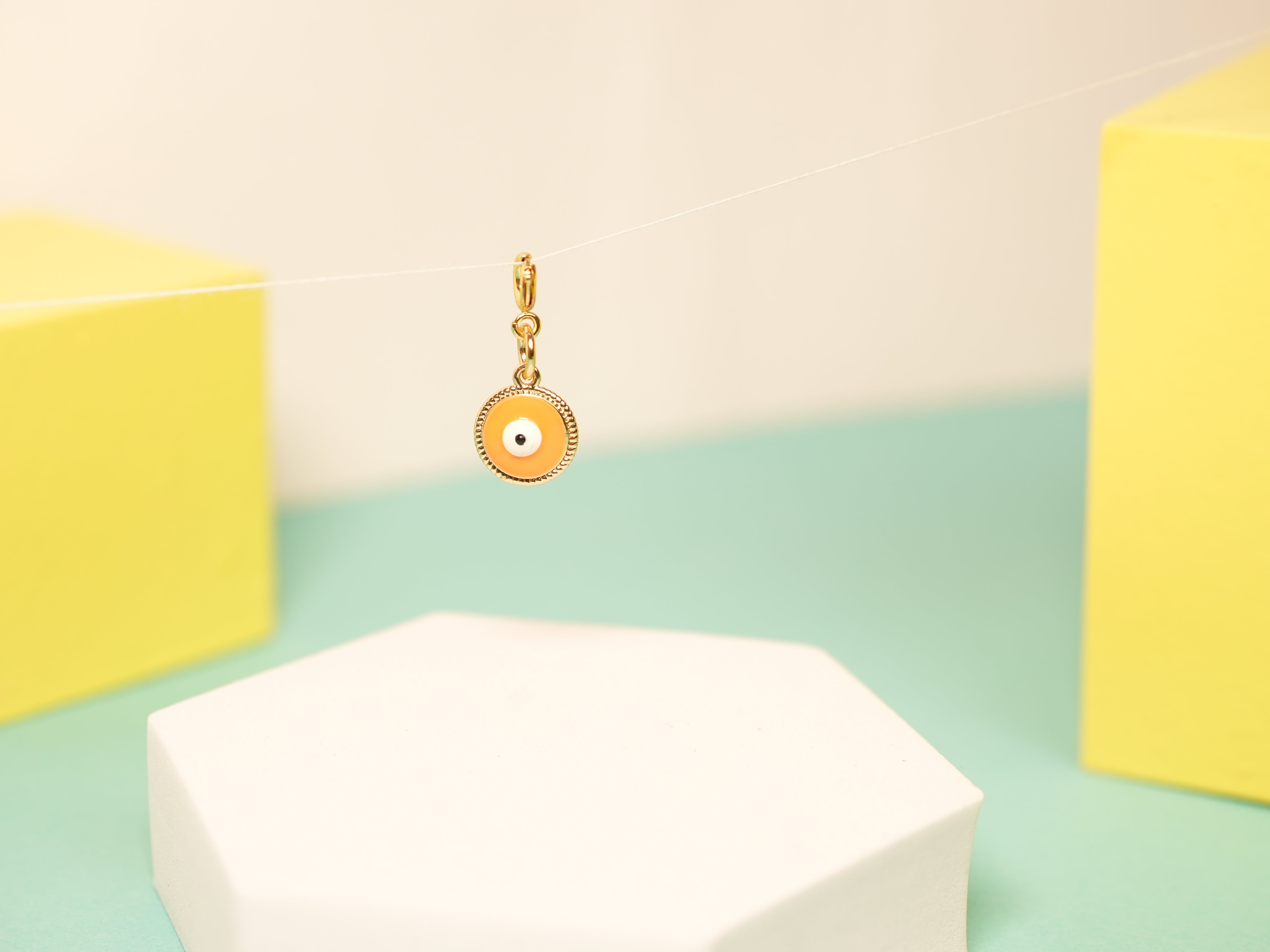 Orange pop evil eye charm