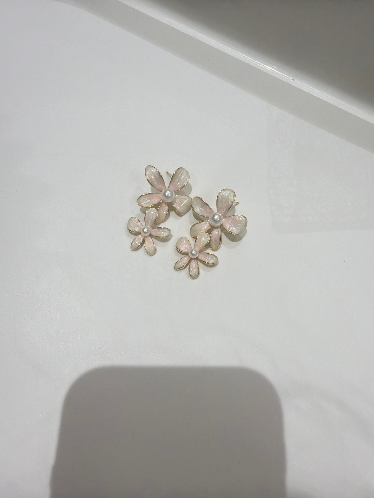 Daga-accessories Blush bloom drop earrings featuring pale pink floral petals with a central pearl accent