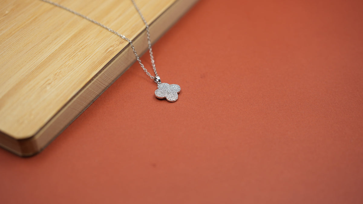 Daga-accessories Clovera silver necklace featuring a four-leaf clover pendant encrusted with sparkling stones