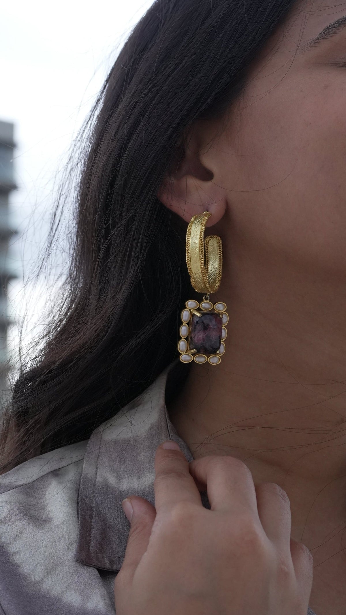 Daga-accessories Crystal Bloom earrings featuring a textured gold hoop with a rectangular stone and pearl border