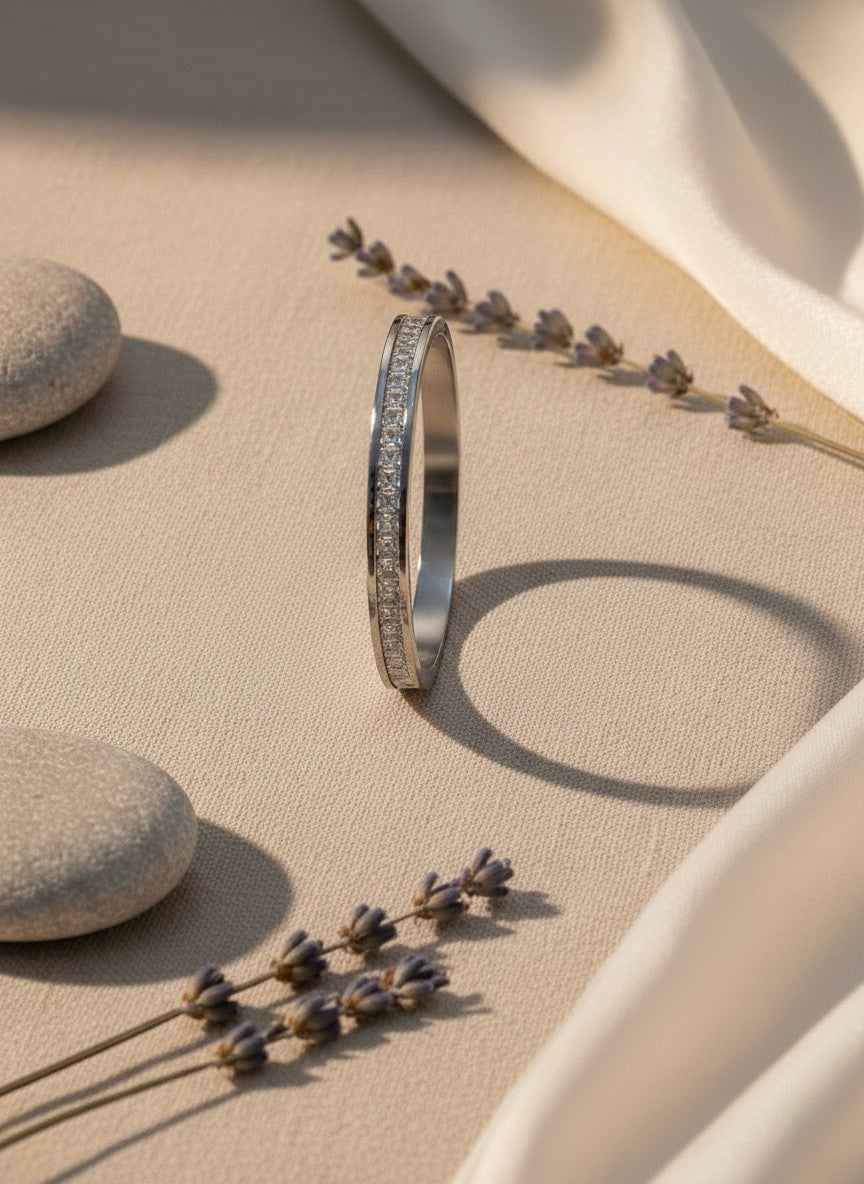 Daga-accessories silver-toned stainless steel hinged bangle bracelet featuring a row of square-cut crystals.