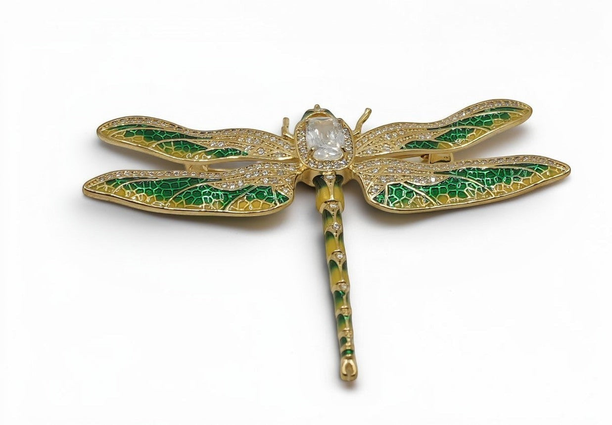 Daga-accessories dragonfly brooch with green enamel wings, gold-tone filigree, and sparkling crystal accents.