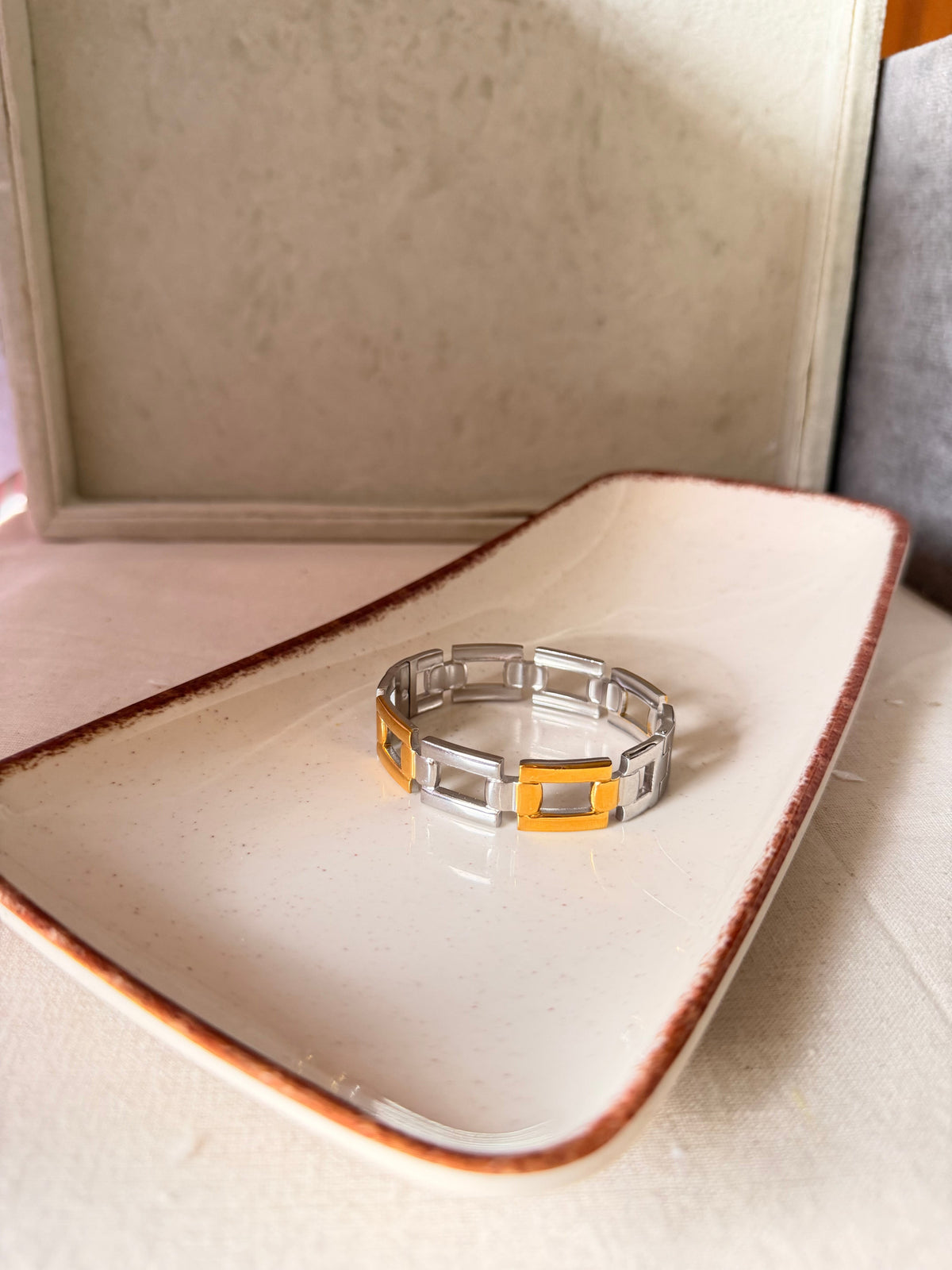 Daga-accessories Dual Armor Cuff featuring a dual-tone silver and gold metal link design on a ceramic tray.