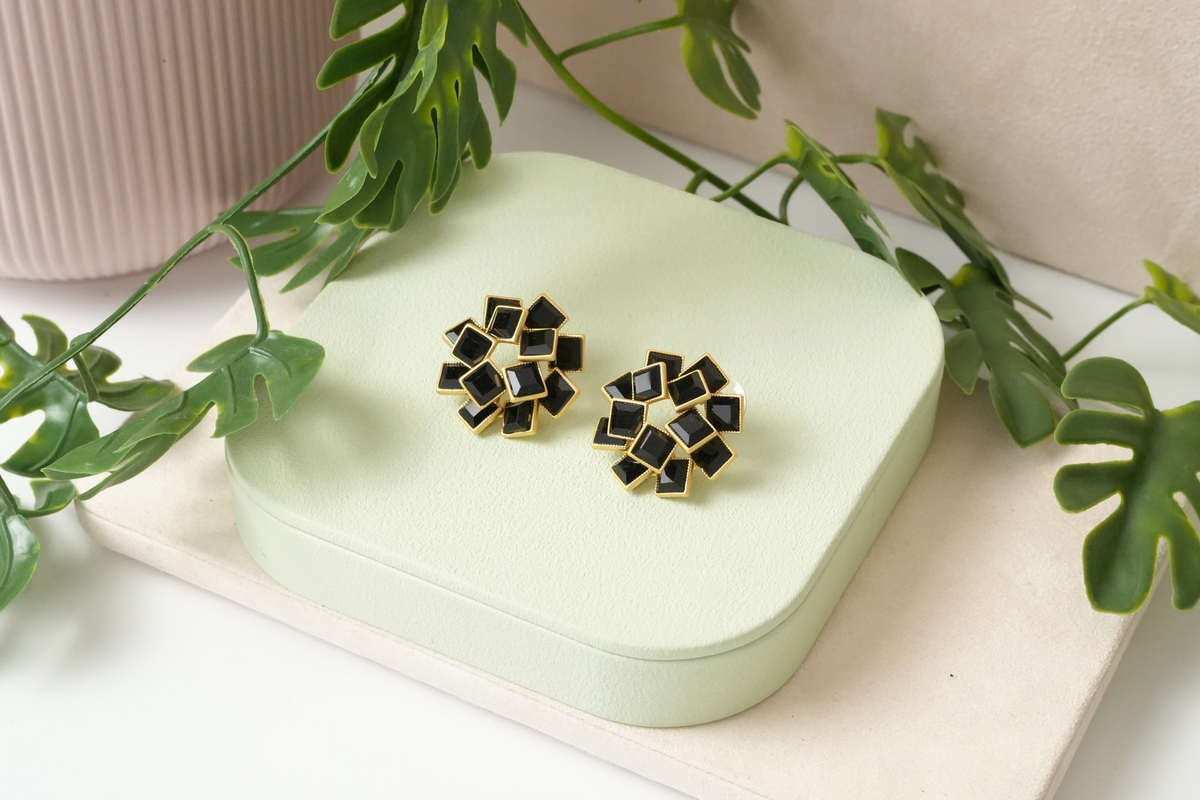 Daga-accessories geometric stud earrings featuring black square-cut stones in a gold-toned cluster setting.