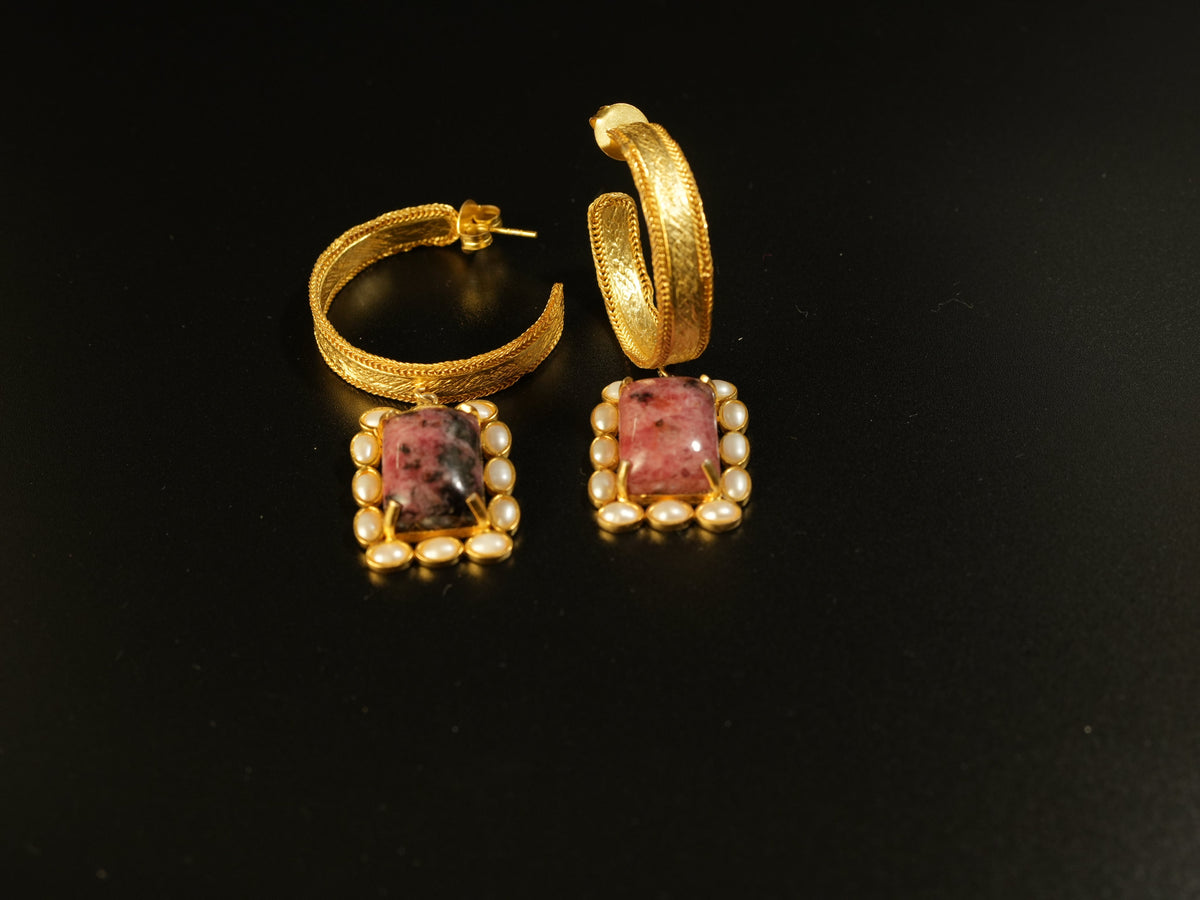 Daga-accessories Crystal Bloom gold hoop earrings featuring a rectangular pink stone framed by small white pearls.