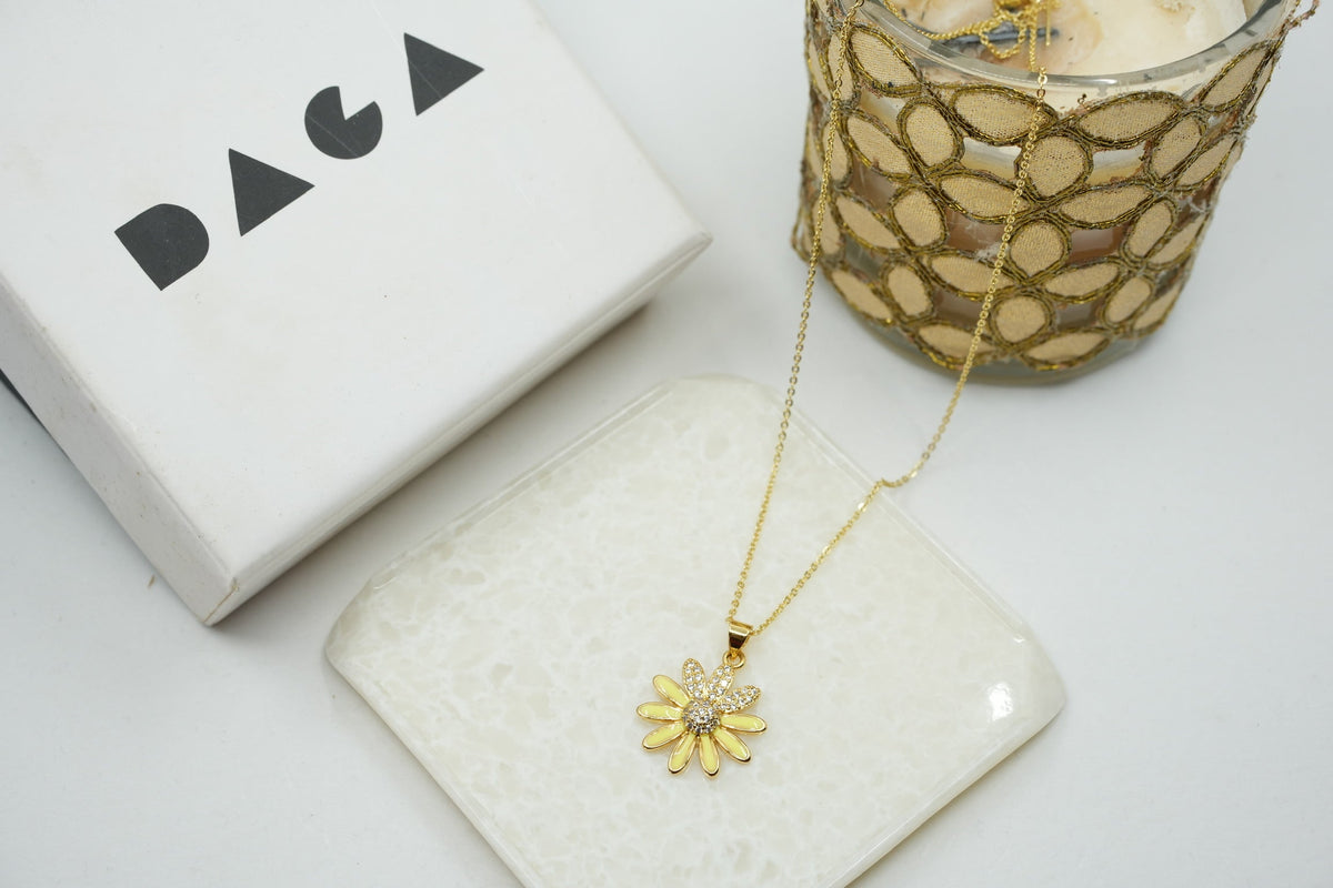 Daga-accessories gold stainless steel necklace featuring a yellow enamel flower pendant with crystal center