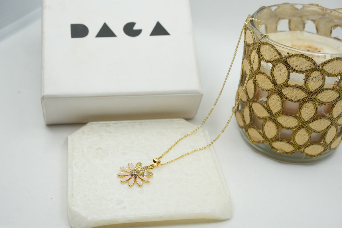 Daga-accessories gold stainless steel necklace featuring a delicate flower pendant with pink enamel and crystal detail