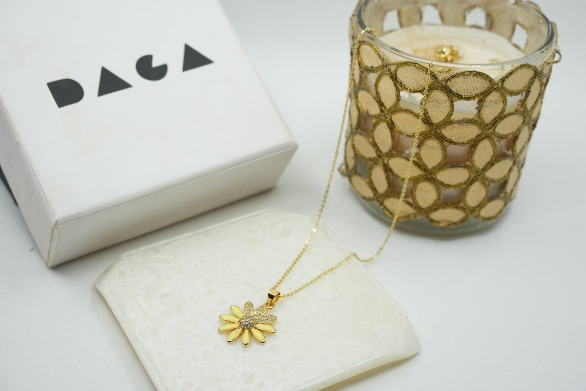 Daga-accessories gold stainless steel necklace featuring a delicate flower pendant with enamel petals and crystal center
