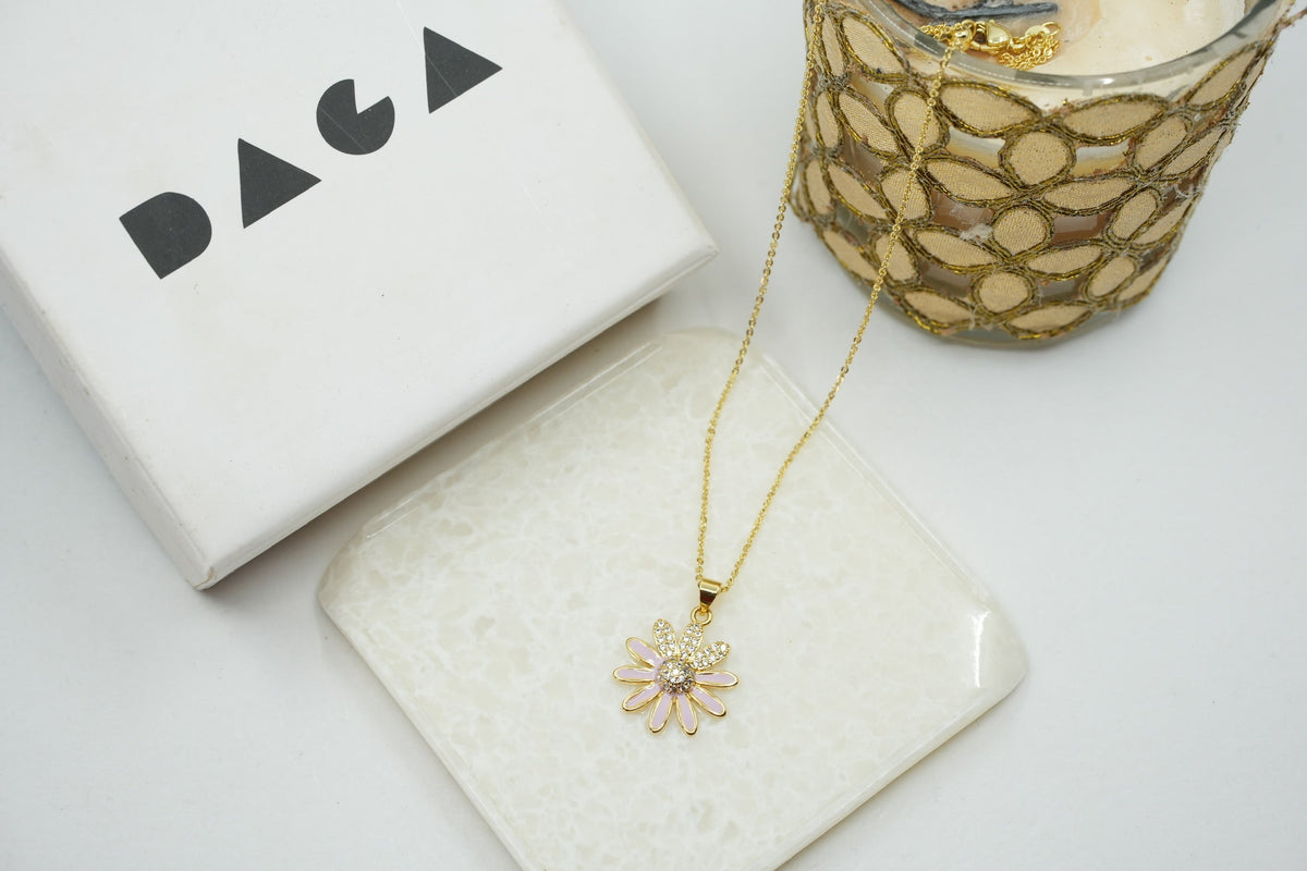 Daga-accessories gold stainless steel necklace featuring a dainty pink enamel flower pendant with crystal accents.