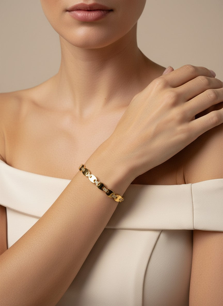 Daga-accessories gold-toned link bracelet with shimmering stone accents worn on a woman's wrist