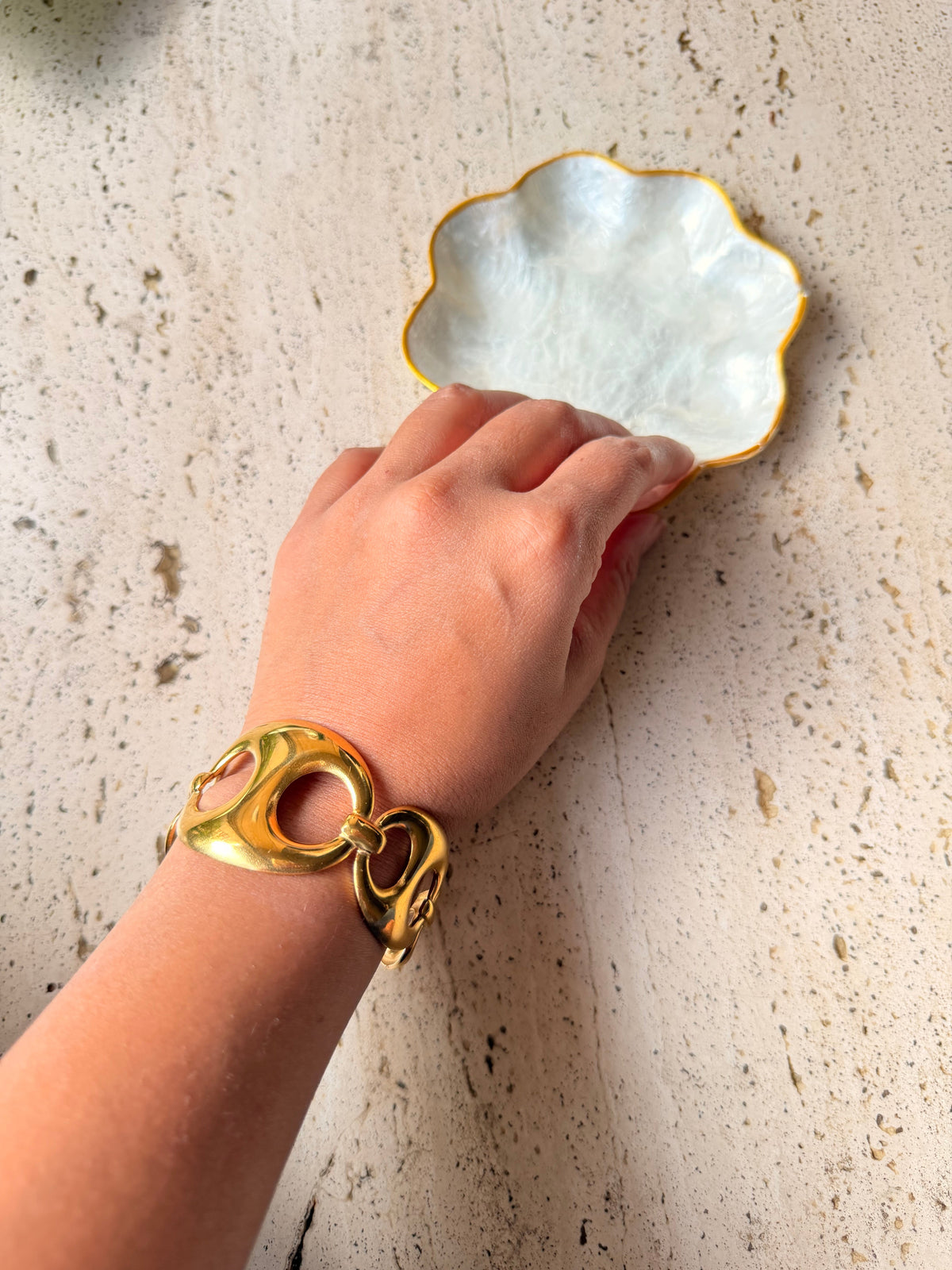 Daga-accessories Heritage Gold Link Cuff worn on a wrist, featuring polished interlocking gold links in a bold style.