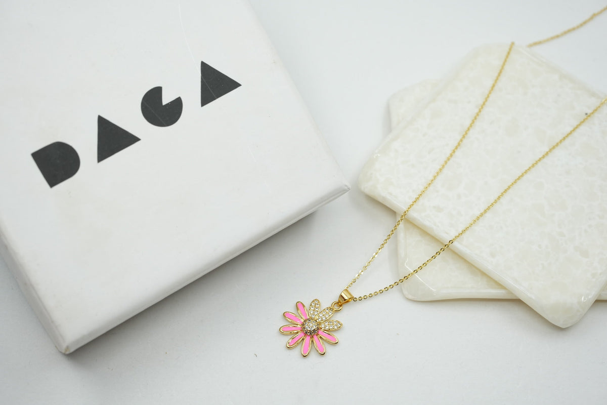 Daga-accessories gold stainless steel necklace featuring a pink enamel flower pendant with sparkling crystal center.