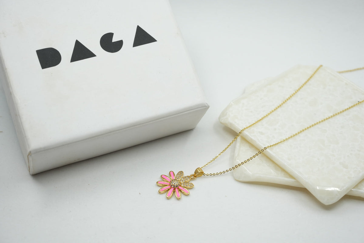 Daga-accessories gold chain necklace with a pink enamel flower pendant featuring sparkling crystal accents