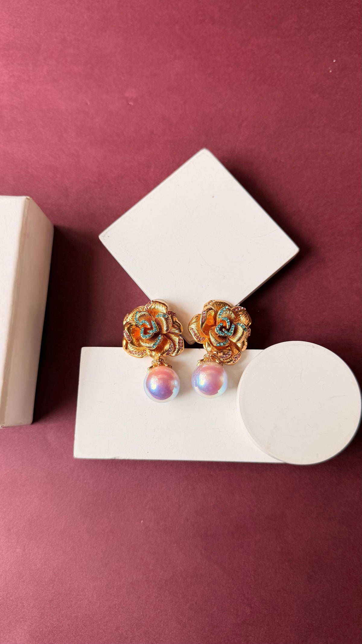 Daga-accessories Golden flora drop earrings featuring mother-of-pearl rose blooms and iridescent pearl drops.