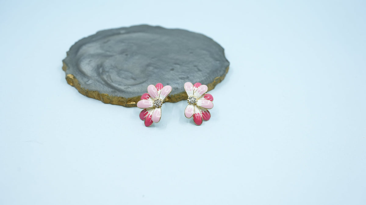 Daga-accessories Half Bloom floral earrings featuring pink and white enamel petals with a central crystal accent.