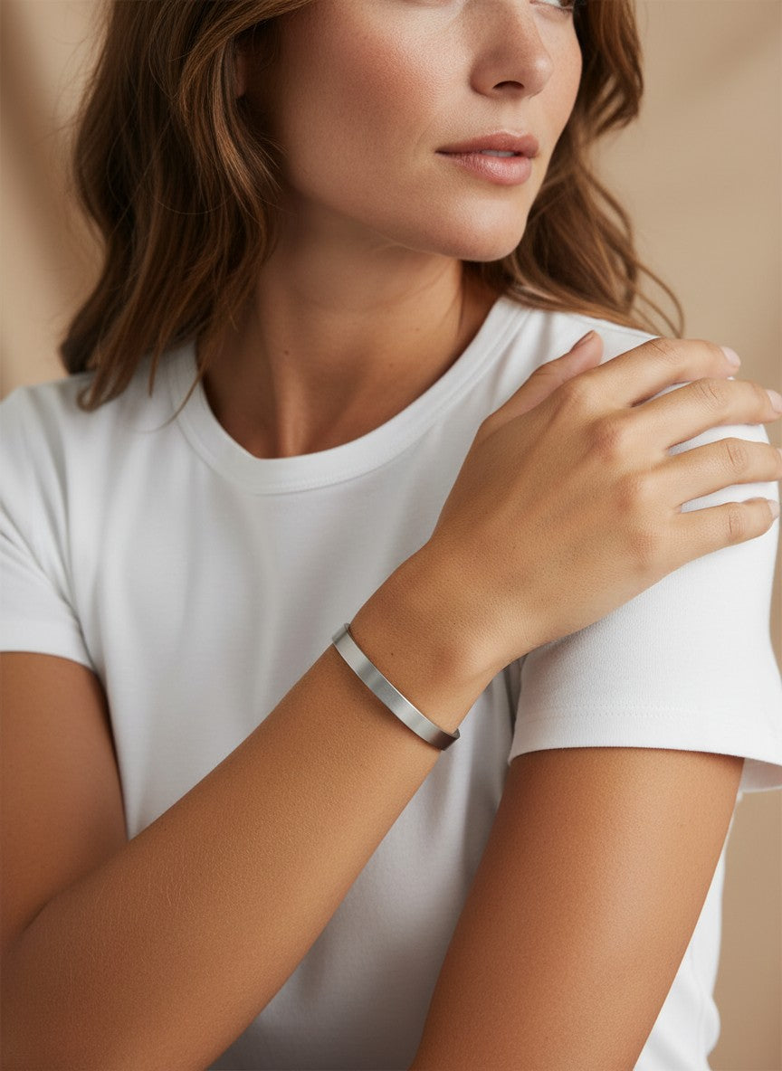 Daga-accessories minimalist silver-toned stainless steel bangle bracelet worn on a woman's wrist