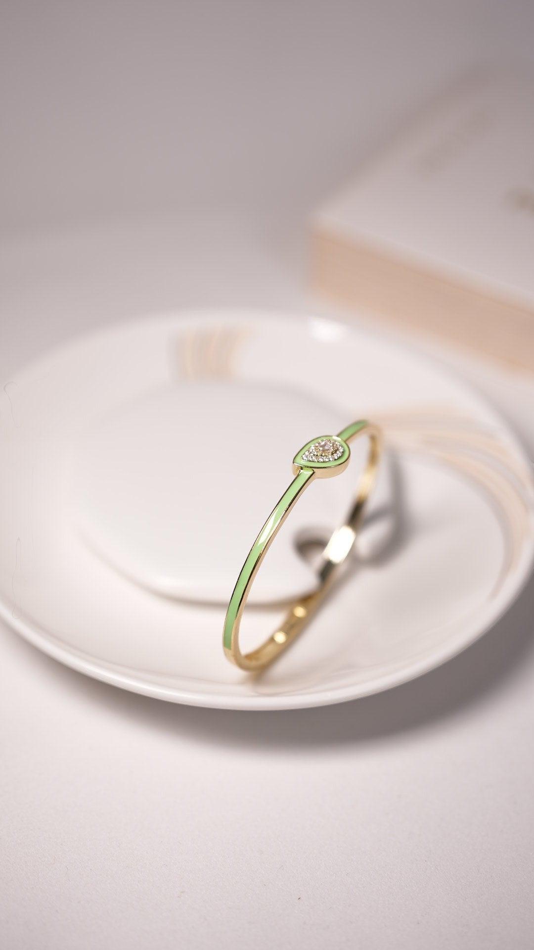 Daga-accessories mint shine drop bracelet featuring a delicate teardrop charm with crystals on a gold-tone band.