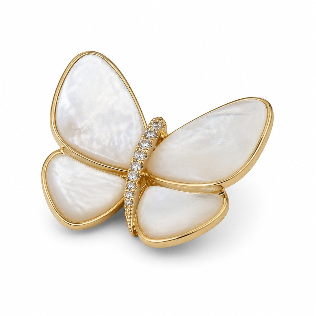 Daga-accessories butterfly brooch featuring iridescent Mother of Pearl wings with a gold-tone frame and crystal body.