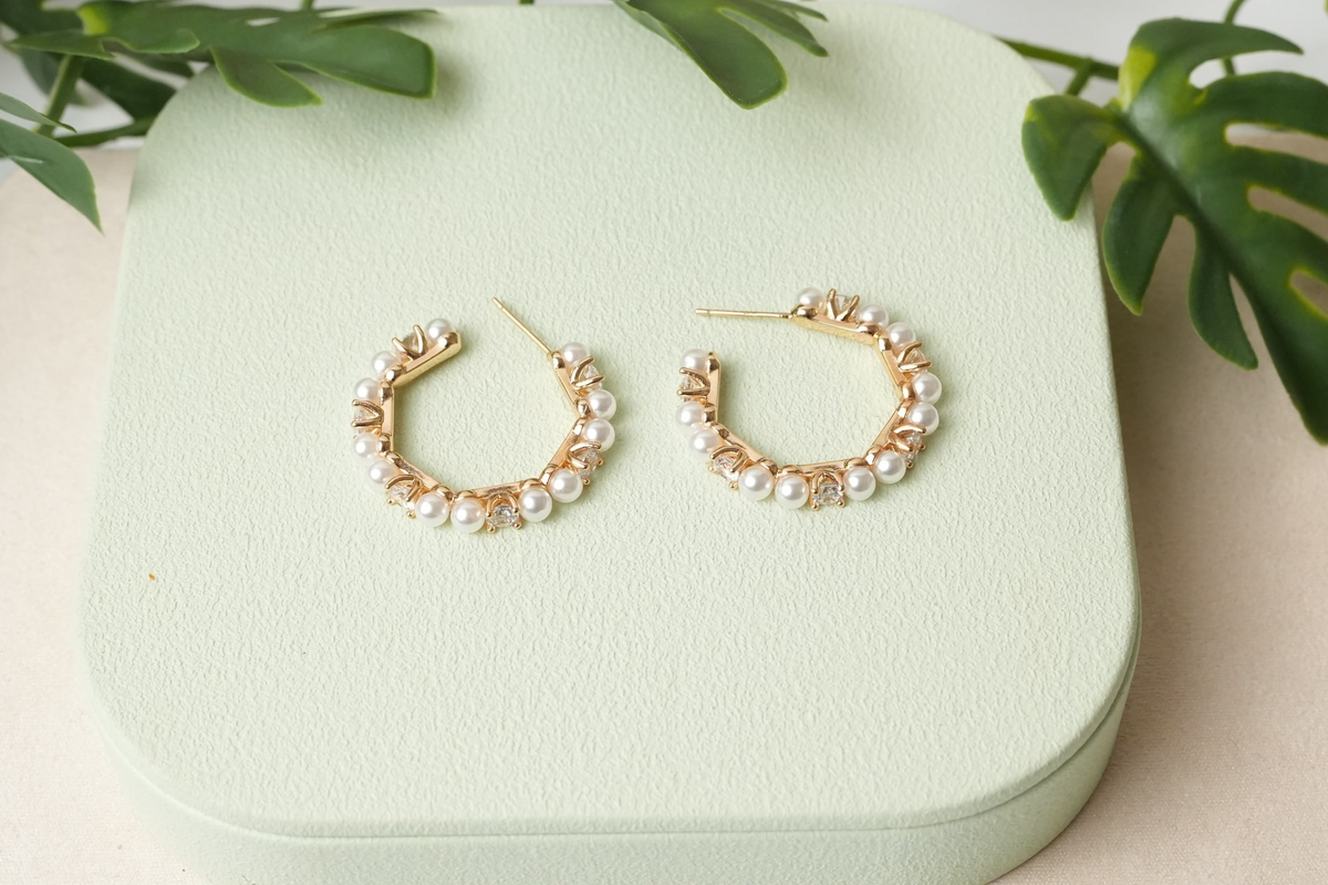 Daga-accessories gold-toned hoop earrings featuring an alternating pattern of faux pearls and clear crystals.
