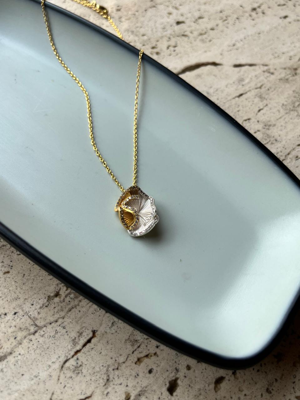 Daga-accessories gold-plated brass necklace featuring a sculptural pencil shaving design with a sparkling Swarovski stone