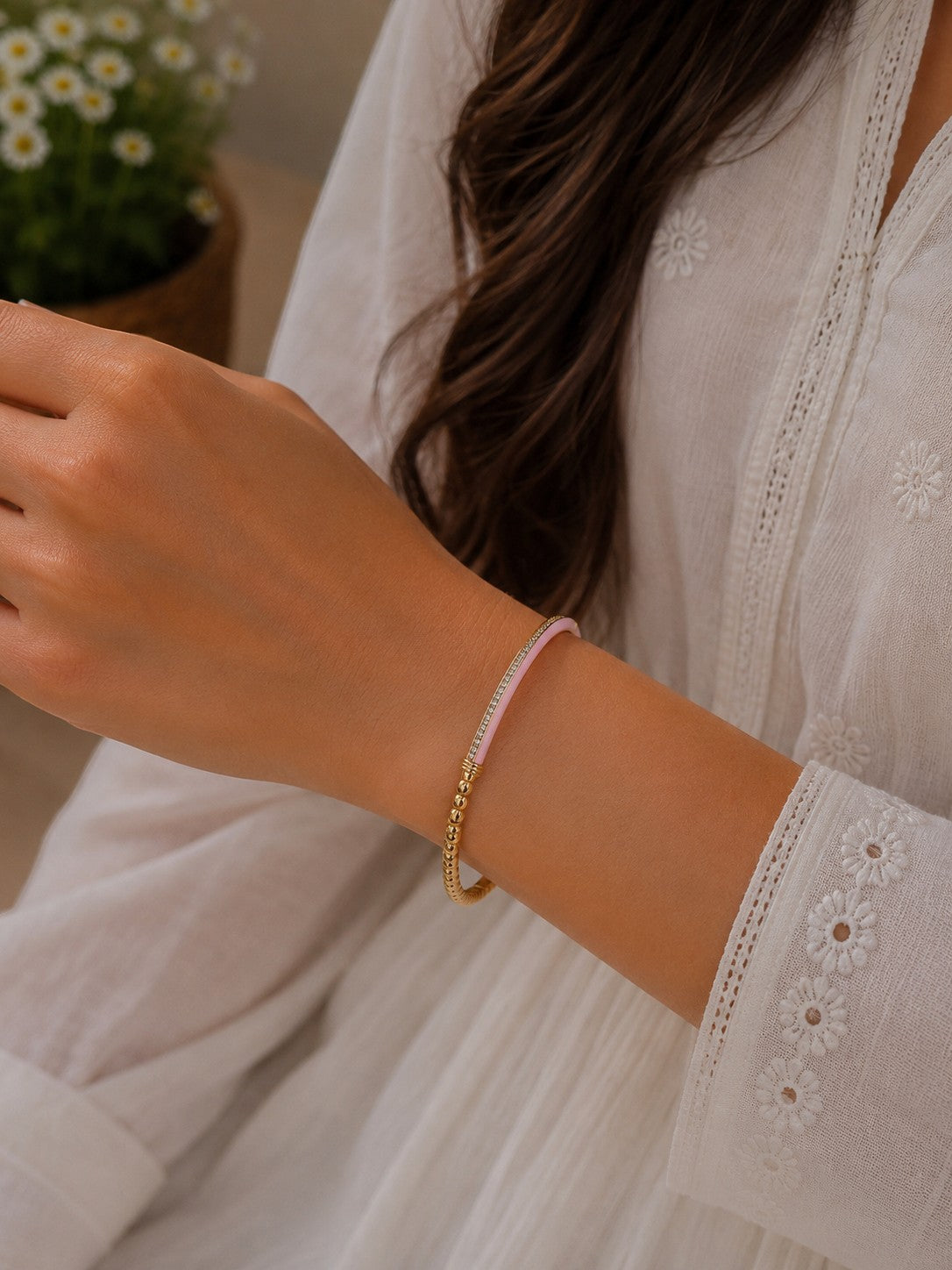 Daga-accessories baby pink enamel and gold beaded slim aura bracelet worn on a woman's wrist
