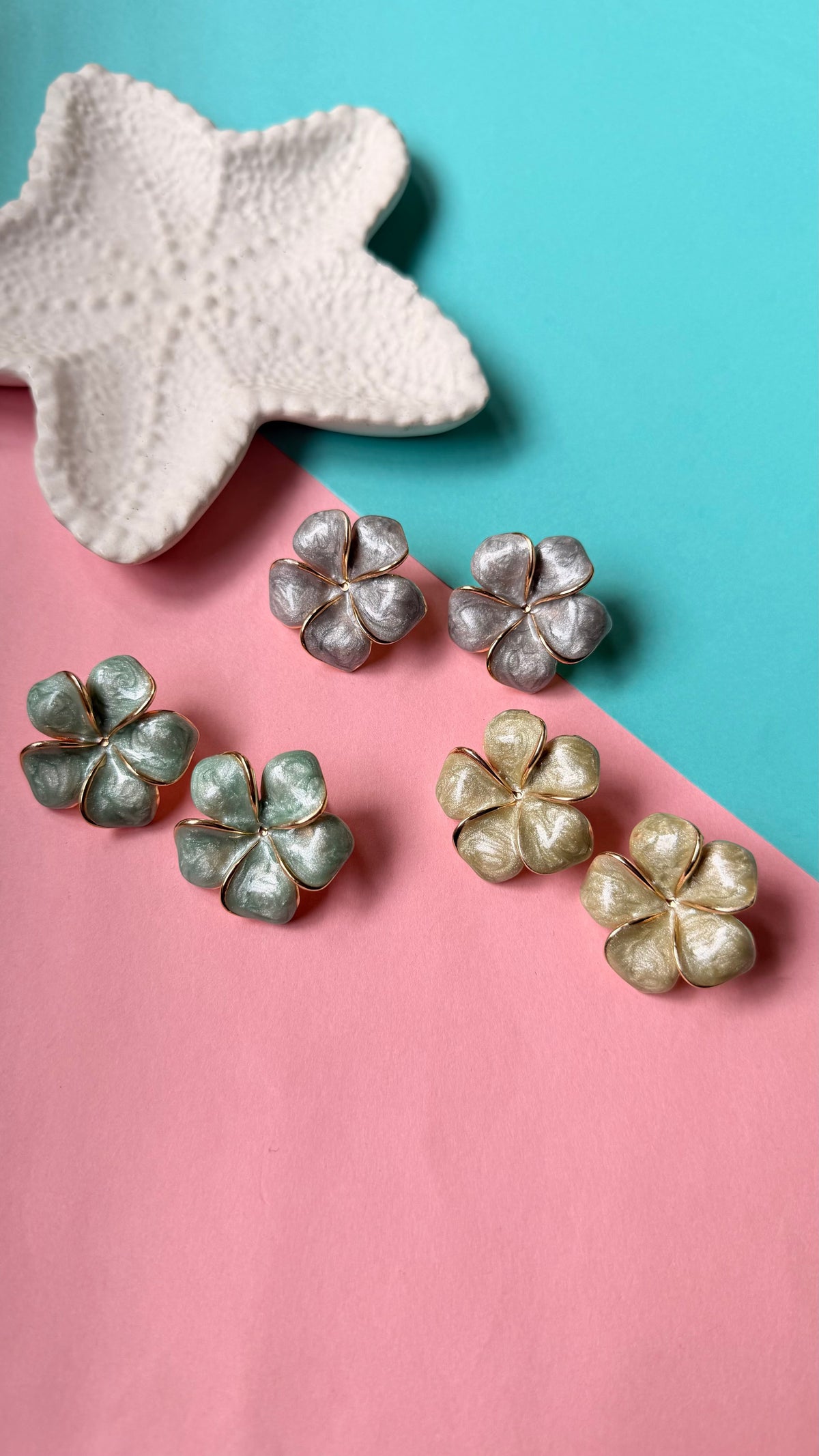 Daga-accessories Pistachio Blossom earrings in green, silver, and gold floral designs on a two-tone background.