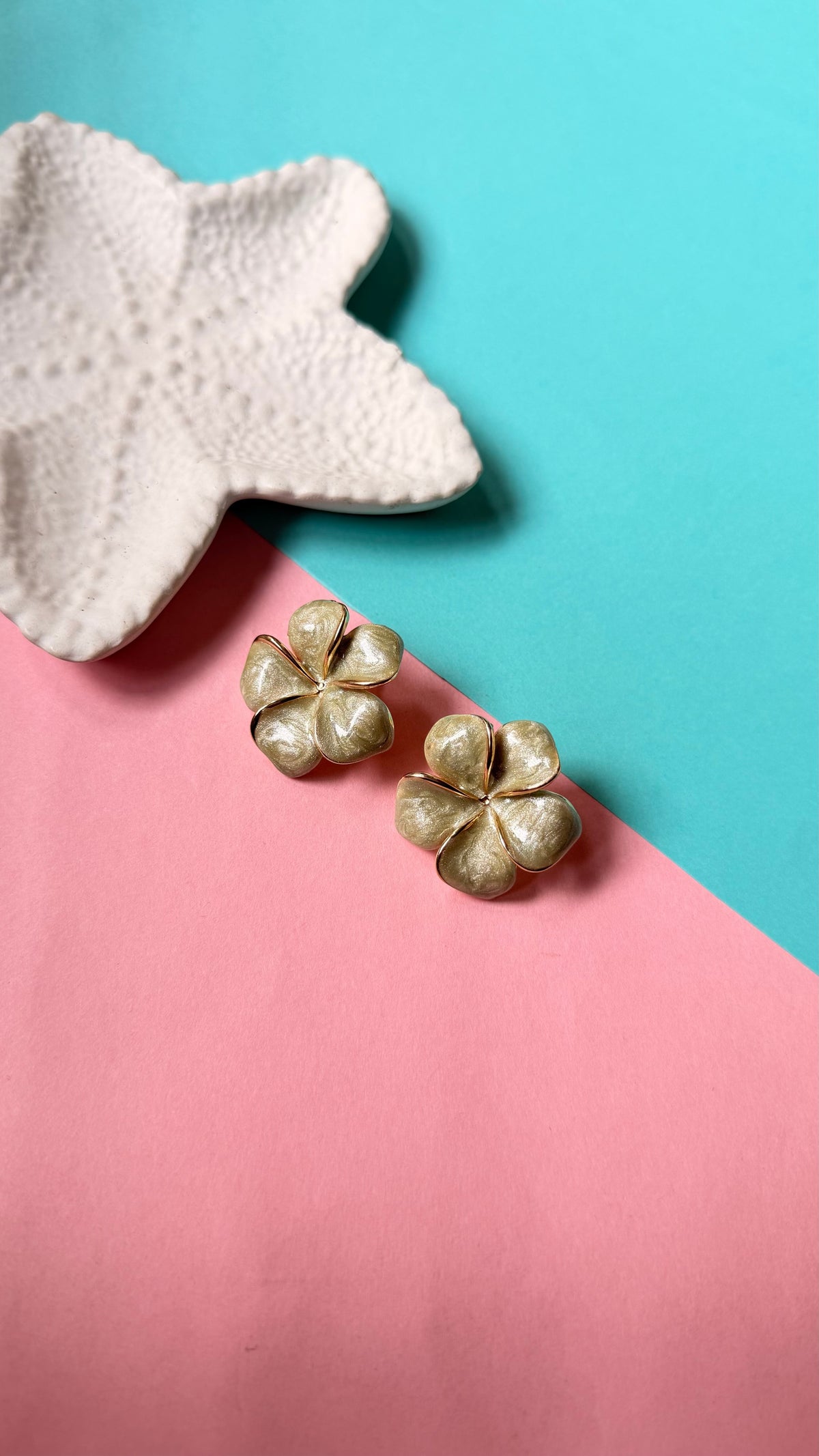 Daga-accessories Pistachio Blossom earrings featuring delicate flower-shaped studs in a soft, shimmering green hue.