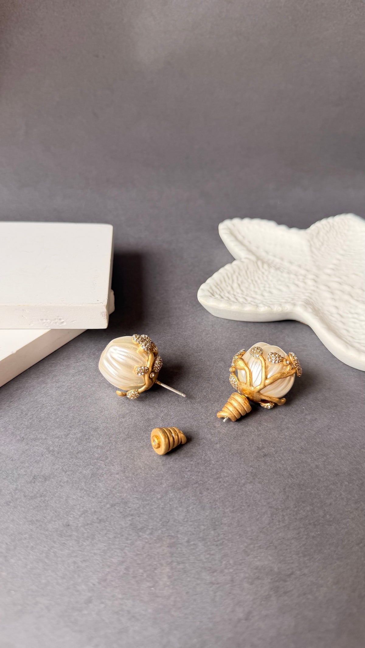 Daga-accessories Sculpted Harmony statement earrings featuring cream pearl-like spheres with gold branch-like detailing.