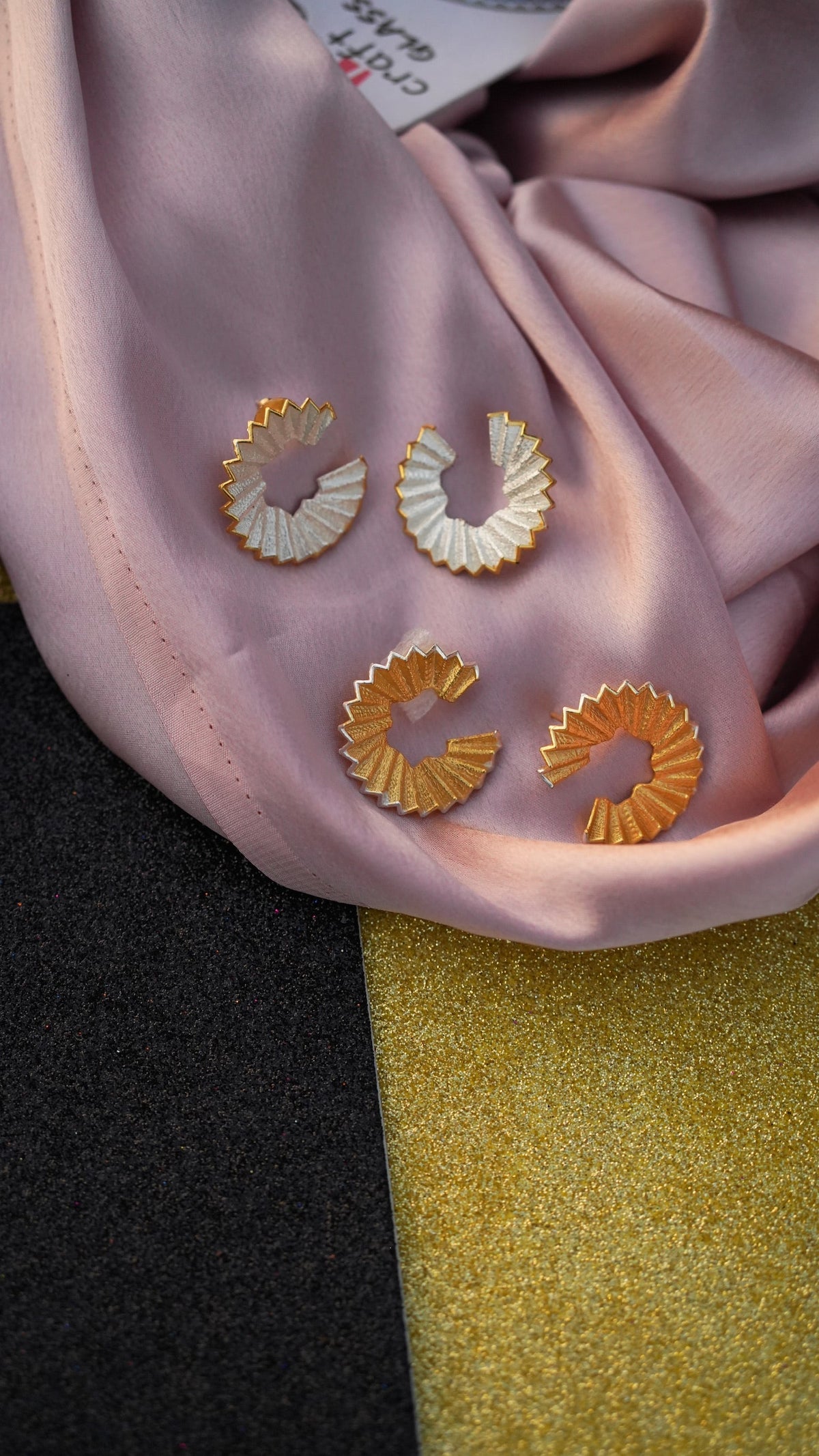 Daga-accessories The Classic Shaved Hoop earrings in gold and silver tones featuring a unique pleated fan design