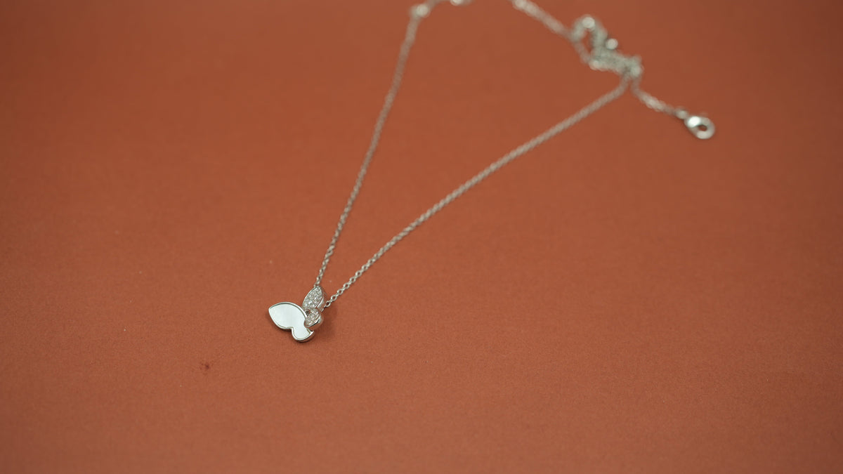Daga-accessories silver-tone butterfly pendant necklace with a smooth inlay and pavé stone detailing