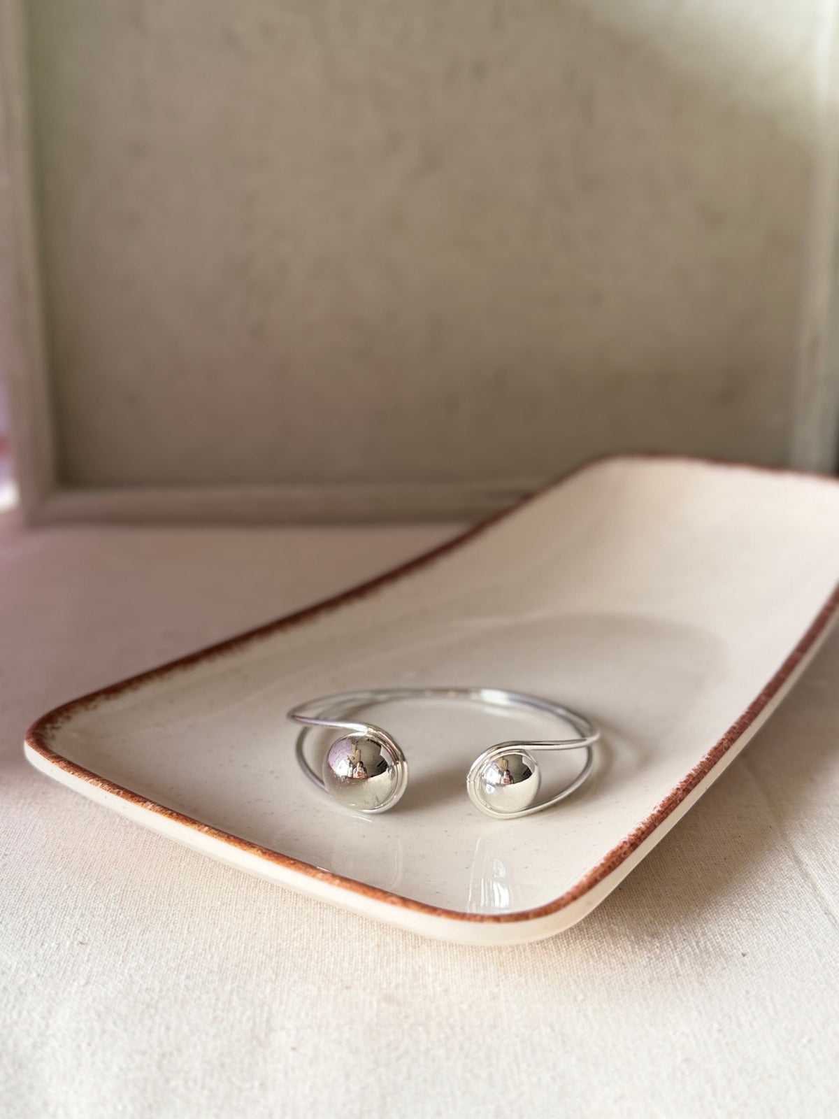 Daga-accessories Dual Marble Silver cuff bracelet featuring a polished open design with two spherical marble accents.