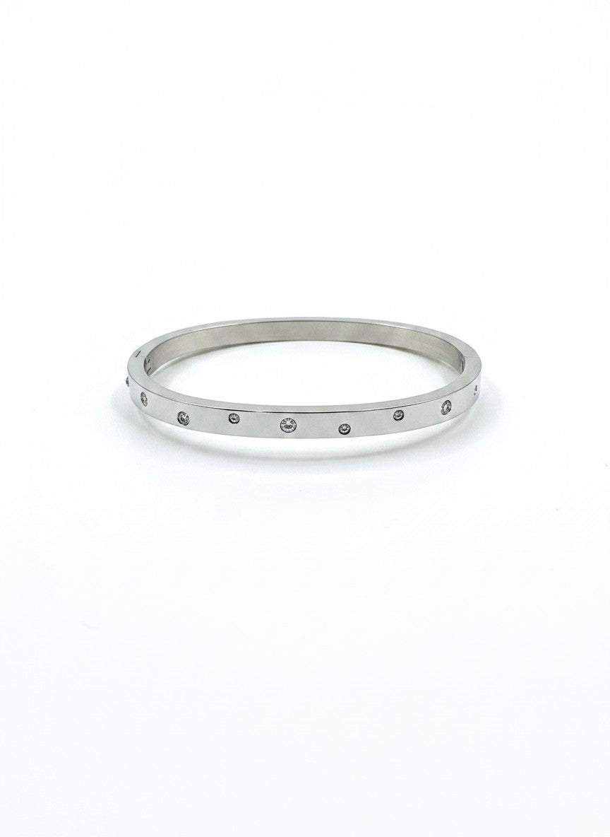 Daga-accessories silver-toned stainless steel bangle bracelet with delicate embedded stones and a polished finish.