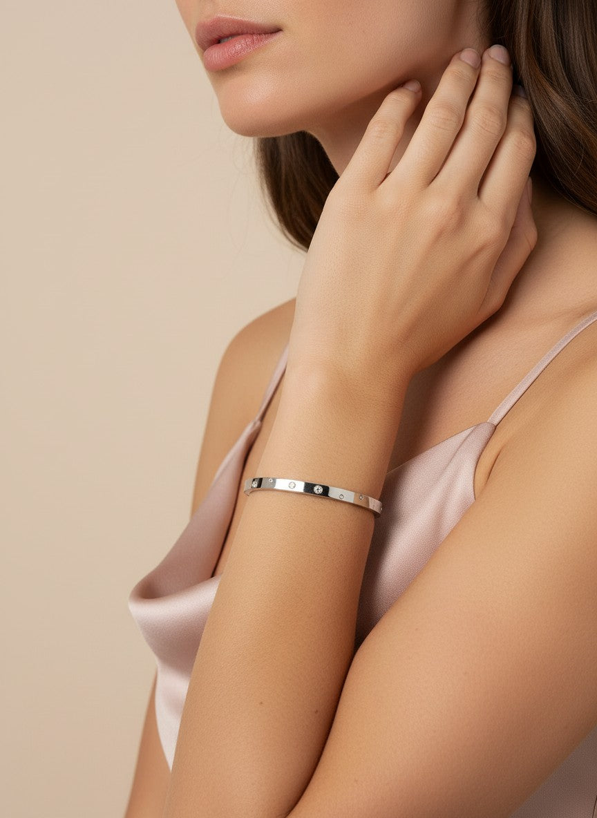 Daga-accessories silver-toned stainless steel bangle with embedded stones worn on a model's wrist