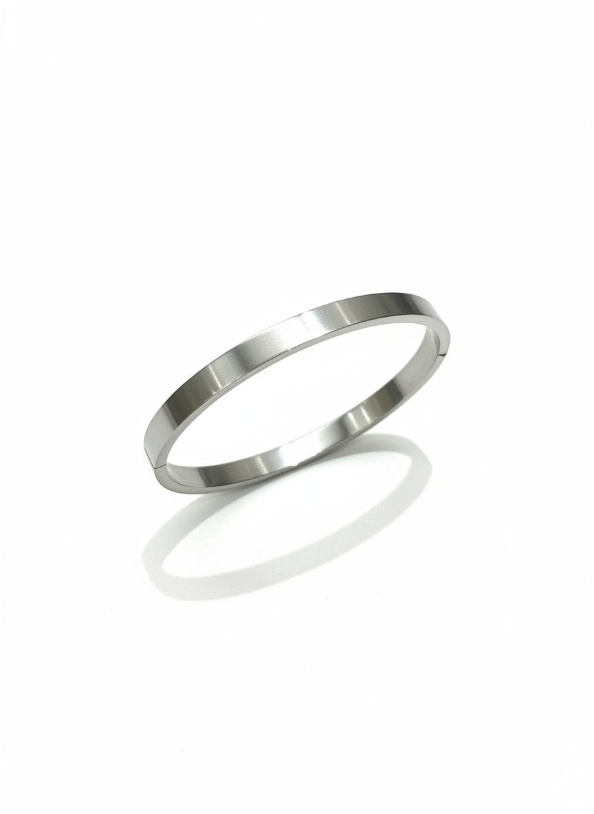 Daga-accessories minimalist stainless steel bangle bracelet with a sleek brushed silver finish on a white background.