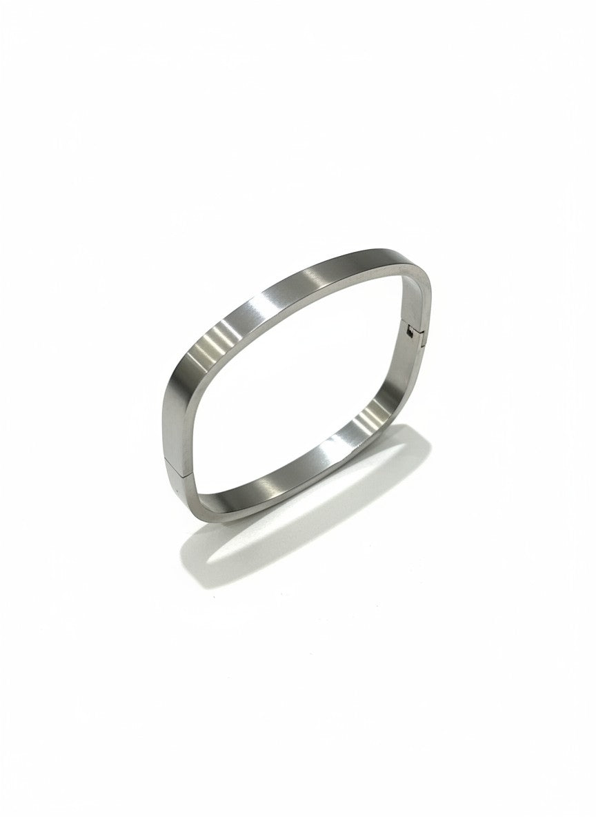 Daga-accessories minimalist square-oval stainless steel bangle bracelet with a polished metallic finish.