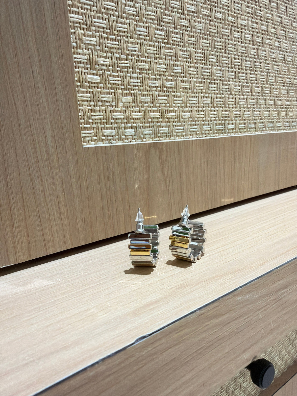 Daga-accessories two-toned hoop earrings with contrasting matte silver and brushed gold textured segments.